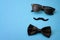 Father day and male hipster fashion concept with minimalist image of a pair of square sunglasses, black bowtie and a fake