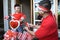 Father decorating bicycle with indonesia flag with his son