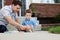 Father Drawing With Chalk on Ground