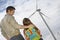 Father Embracing Daughter At Wind Farm