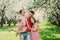 Father enjoying spring walk with two smiling kid daughters