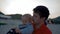 Father entertains little son walking on beach at sunset