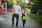 Father escorted to school by his son.