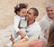 Father, family and beach this summer, happy to be with his child. People on a picnic on vacation, smiling and baby is