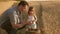 Father farmer plays with little son, daughter in the field. grain of wheat in hands of child. Dad is an agronomist and