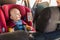 Father fasten his baby in car seat