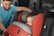 Father fastening baby to child safety seat inside