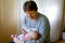 Father feeding newborn baby daughter with milk in nursing bottle