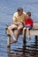 Father Fishing With His Son On A Jetty