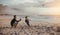 Father flying drone and son running on beach