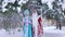 Father Frost and Snow Maiden standing under snow-covered tree