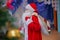 Father Frost speaks with a microphone . Santa Claus is singing Christmas songs against . Man in Santa Claus suit posing