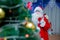 Father Frost speaks with a microphone . Santa Claus is singing Christmas songs against . Man in Santa Claus suit posing with