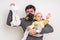 Father with gas mask is holding stinky diaper and little baby