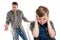 Father gesturing and quarreling with scared little boy closing ears