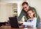 Father, girl and laptop for remote learning in home, internet and school website or online homework. Daddy, daughter and