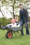 Father Giving Children Ride In Wheelbarrow