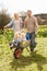 Father Giving Children Ride In Wheelbarrow