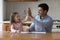 Father giving high five praising daughter for success in paintings