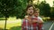 Father giving son piggyback riding in park. Man and boy talking on street