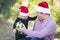 Father Giving Young Daughter Christmas Gift Outdoors