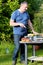 Father grilling meat in the garden for lunch