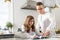 Father guiding daughter in doing homework at table