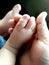 Father hand holding baby feet - Family concept