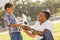 Father Hands New Soccer Ball to Mixed Race Son