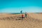 Father with happy kids - son and daughter - travel in sand dunes