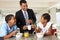 Father Having Breakfast With Children Before Work