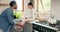 Father, help and girl child with shoes tie, high five and bonding in kitchen in their home. Family, love and hands in