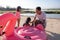 Father helped his daughter pump a flamingo buoy