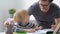 Father helping child do his homework at home. Homeschooling, distance learning, online studying, remote education for kids during