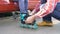 Father helping daughter dresses roller skates closeup