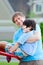 Father helping disabled seven year old son play at playground