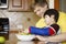 Father helping disabled son in the kitchen