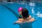 Father helping his little daughter overcome fear of swimming. Young father teaching his fearful daughter how to swim in
