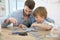 Father helping his son building an aeroplane toy