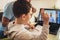 Father helps his son with home work. Boy in video conference with teacher on laptop at home