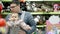 Father with his child in baby carrier in the shopping mall, attachment parenting concept