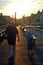 A father and his child stroll the boardwalk at sunset