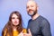 Father and his daughter interactions. Models man in his 40s, bald with grey beard. girl teenager with long hair. Thumbs up. Blue