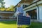 Father with his little daughter carring solar panel at their backyard. Alternative energy, saving resources and