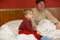 Father and his little son on the bed at hotel on vacation.