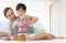 Father and his mixed-race son playing colorful wooden block together with joy and happiness in home bed room. Idea for learning