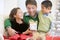 Father And His Son And Daughter Sitting On Sofa