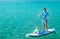 Father with His Son on SUP. Stand Up Paddling.