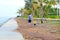 A father and his son walking along the beach in Paknampran Pranburi, Thailand December 24, 2018