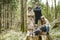 Father and his three kids hiking in the woods. Dad, his toddler son and teenage daughters having fun on a walking trail on spring